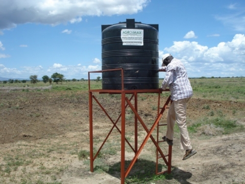 LC III Chairperson Lokopo SC, Napak checks one of the irrigation tanks