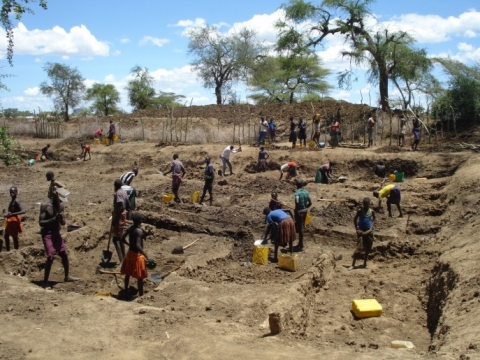 Youth work on a water pond in Lotome Sub County, Napak District